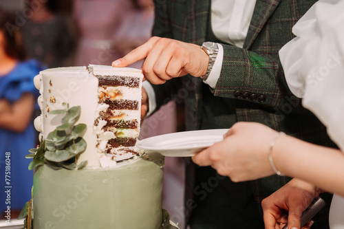 The image shows a couple of people cutting a cake, possibly at a wedding or a birthday celebration 6889.