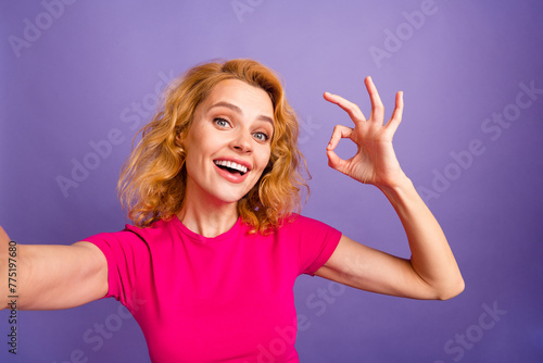 Photo of pretty adorable nice woman blogger wear stylish pink clothes okey sign isolated on purple color background