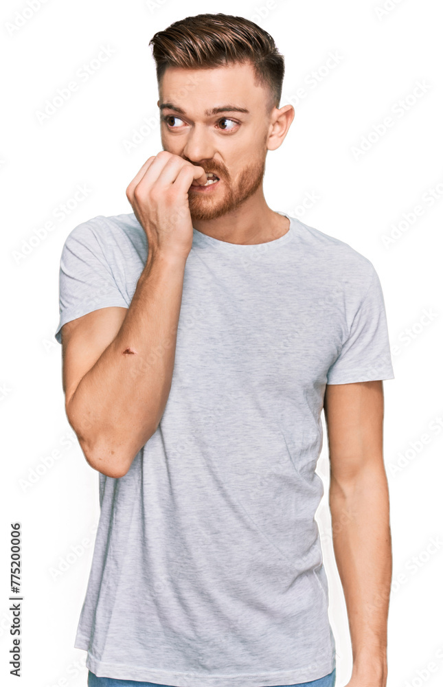 Young redhead man wearing casual grey t shirt looking stressed and nervous with hands on mouth biting nails. anxiety problem. Young redhead man wearing casual grey t shirt looking stressed and nervous with hands on mouth biting nails. anxiety problem.