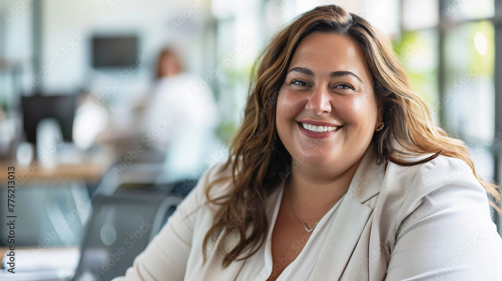 Happy, attractive, mature, plus-sized businesswoman in office environment Happy, attractive, mature, plus-sized businesswoman in office environment