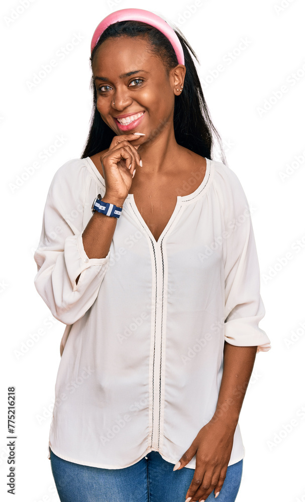 Young black woman wearing casual clothes looking confident at the camera with smile with crossed arms and hand raised on chin. thinking positive. Young black woman wearing casual clothes looking confident at the camera with smile with crossed arms and hand raised on chin. thinking positive.