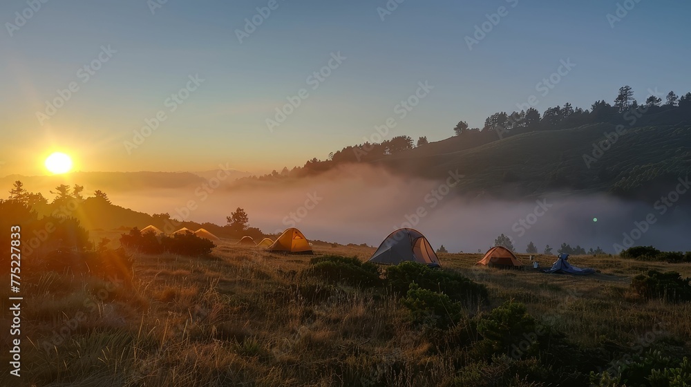 Sunrise over a misty campsite, tents aglow, days promise