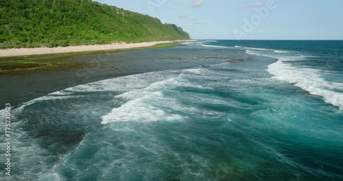 Drone view of Bali. Top view of blue wave on Nyang Nyang beach at low tide photo