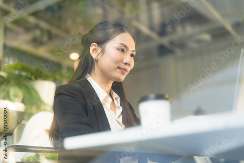 Focused businesswoman working at laptop in cafe