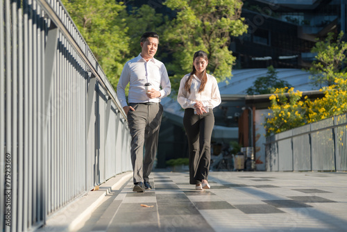 Business colleagues walking in urban setting © Naypong Studio