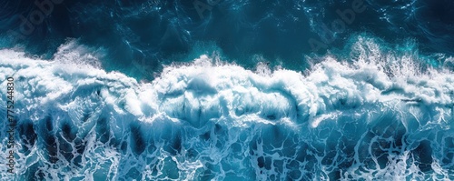 This vivid aerial shot captures the immense power and beauty of ocean waves in the sea, epitomizing nature's untamed force.