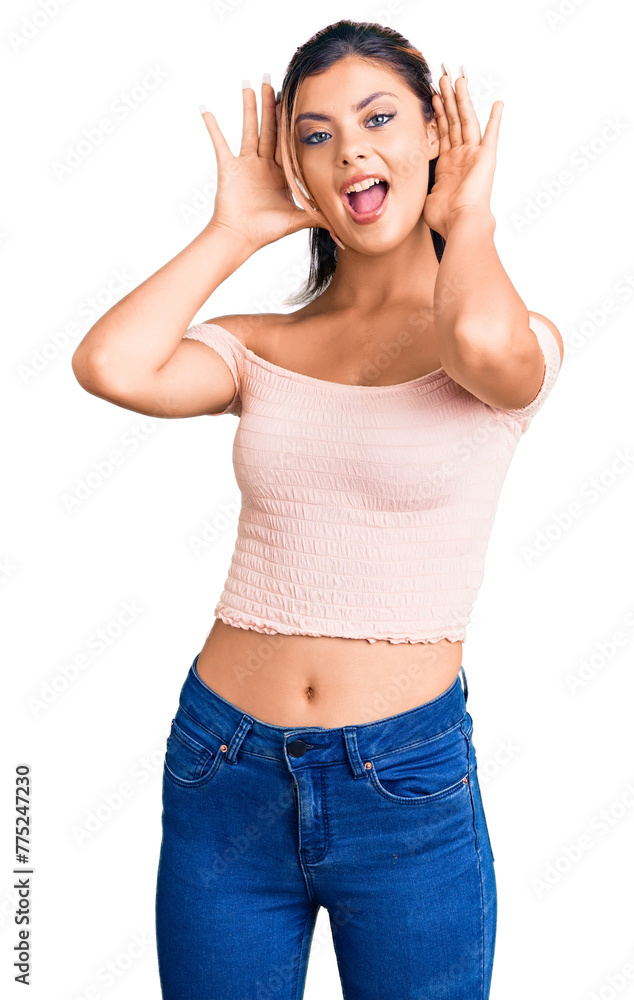 Young beautiful woman wearing casual clothes smiling cheerful playing peek a boo with hands showing face. surprised and exited Young beautiful woman wearing casual clothes smiling cheerful playing peek a boo with hands showing face. surprised and exited