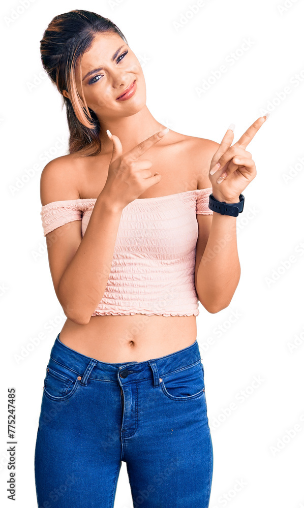 Young beautiful woman wearing casual clothes pointing aside worried and nervous with both hands, concerned and surprised expression Young beautiful woman wearing casual clothes pointing aside worried and nervous with both hands, concerned and surprised expression