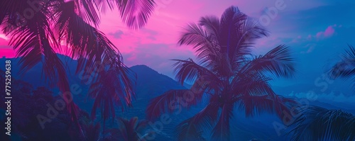 Tropical sunset with palm trees and mountains