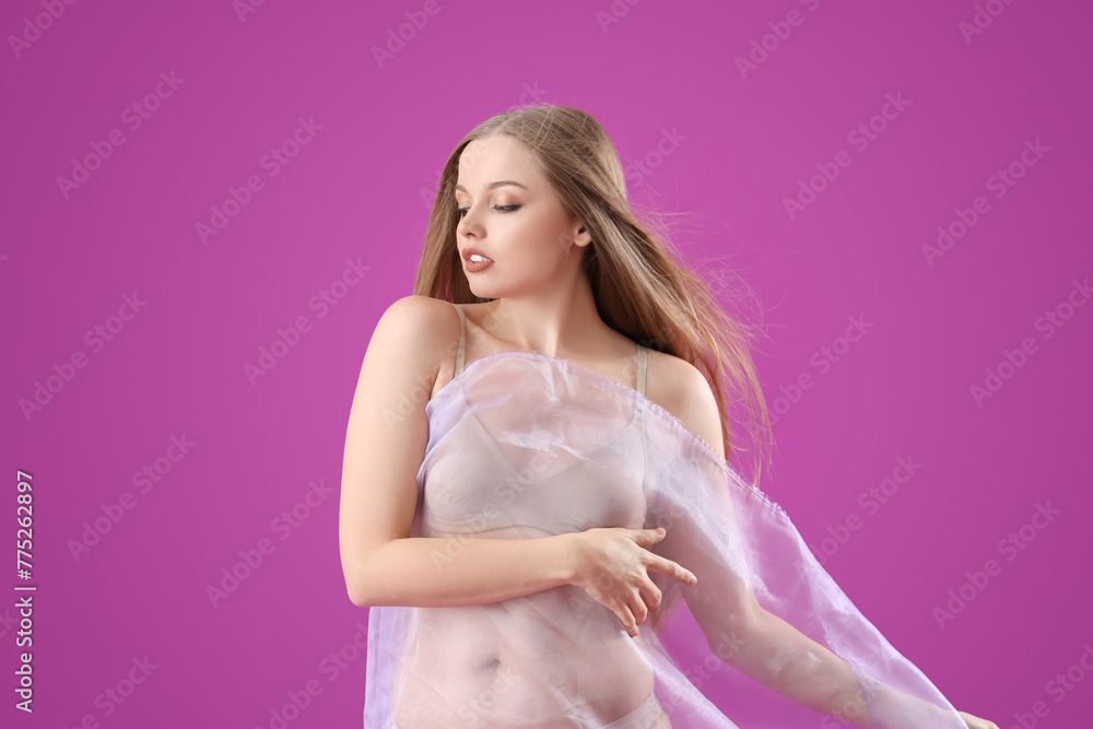 Beautiful young woman in underwear with fabric on purple background Beautiful young woman in underwear with fabric on purple background