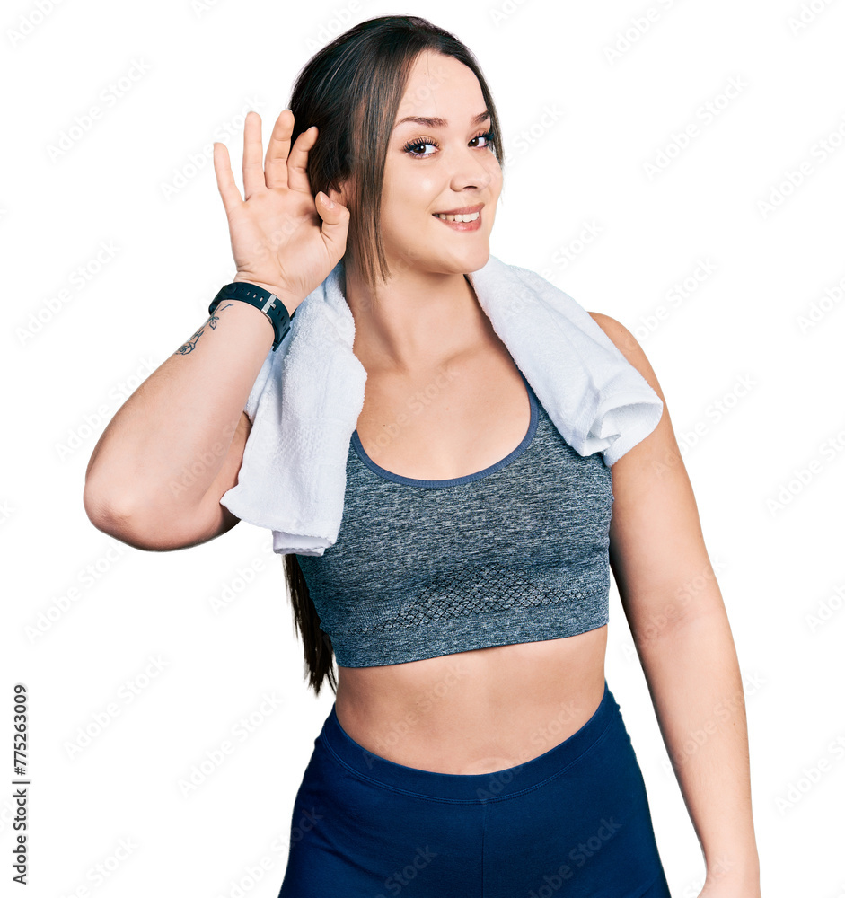Young hispanic girl wearing sportswear and towel smiling with hand over ear listening an hearing to rumor or gossip. deafness concept. Young hispanic girl wearing sportswear and towel smiling with hand over ear listening an hearing to rumor or gossip. deafness concept.