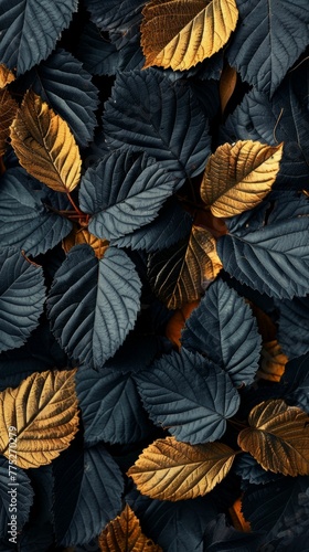 A natural backdrop featuring a detailed texture of leaves in striking dark blue and golden hues  symbolizing seasonal change.