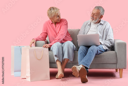 Mature couple with laptop a...