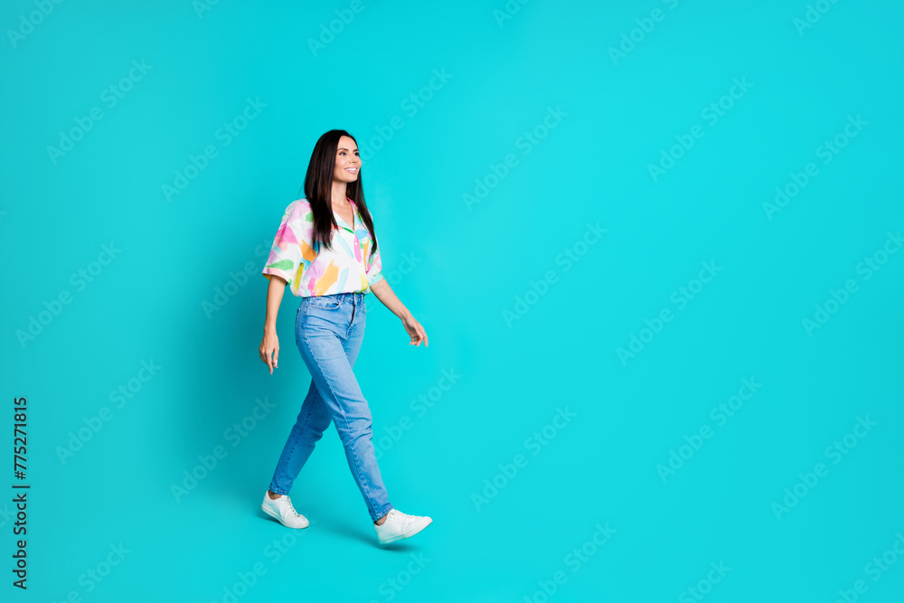 Photo of nice cool cheerful cute woman dressed stylish clothes going looking empty space isolated on cyan color background Photo of nice cool cheerful cute woman dressed stylish clothes going looking empty space isolated on cyan color background