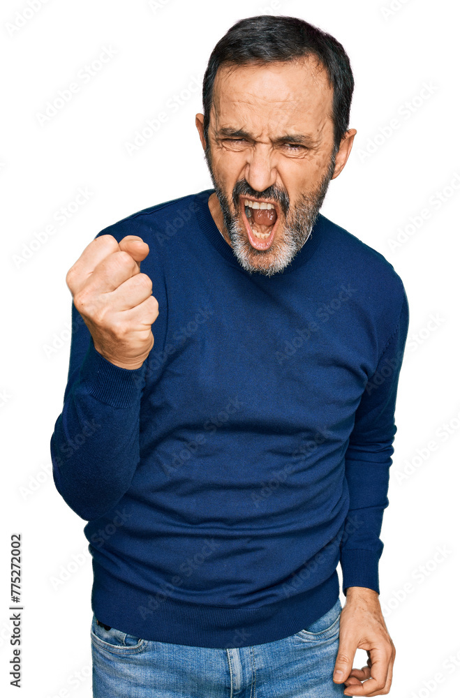 Middle age hispanic man wearing casual clothes angry and mad raising fist frustrated and furious while shouting with anger. rage and aggressive concept. Middle age hispanic man wearing casual clothes angry and mad raising fist frustrated and furious while shouting with anger. rage and aggressive concept.
