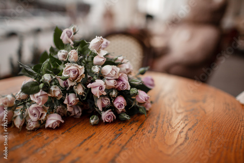 Close-up of a bouquete of roses in the table in cafe photo