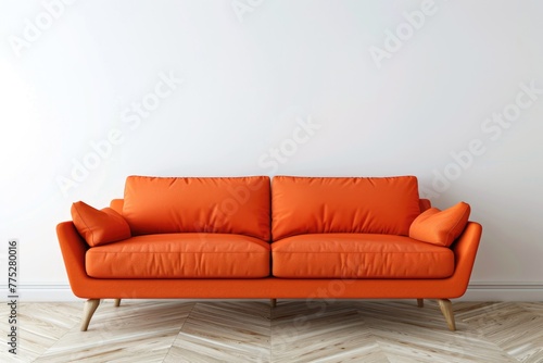 Stylish modern orange couch against a clean white wall. Perfect for interior design concepts