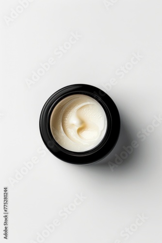 A jar of cream on a table, suitable for beauty or skincare concepts