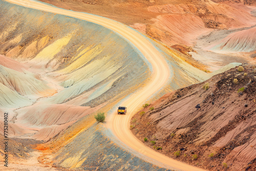 Winding road through colorful desert hills.