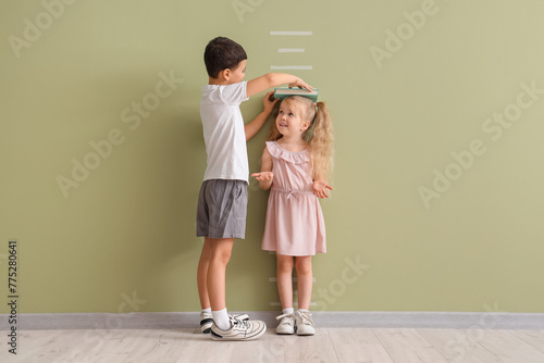 Cute little kids measuring ...