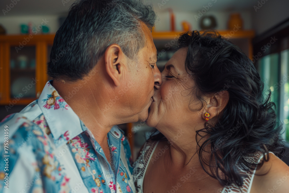 A man and a woman are kissing in a kitchen A man and a woman are kissing in a kitchen