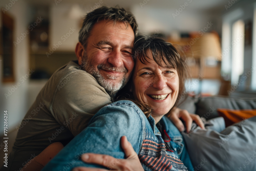 A man and woman are hugging and smiling for the camera A man and woman are hugging and smiling for the camera