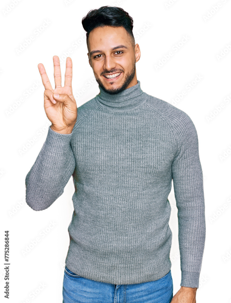 Young arab man wearing casual clothes showing and pointing up with fingers number three while smiling confident and happy. Young arab man wearing casual clothes showing and pointing up with fingers number three while smiling confident and happy.