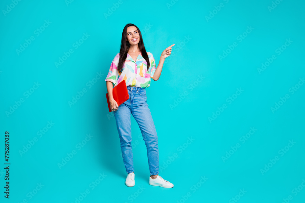 Full size photo of pretty young woman laptop direct finger empty space wear shirt isolated on teal color background Full size photo of pretty young woman laptop direct finger empty space wear shirt isolated on teal color background