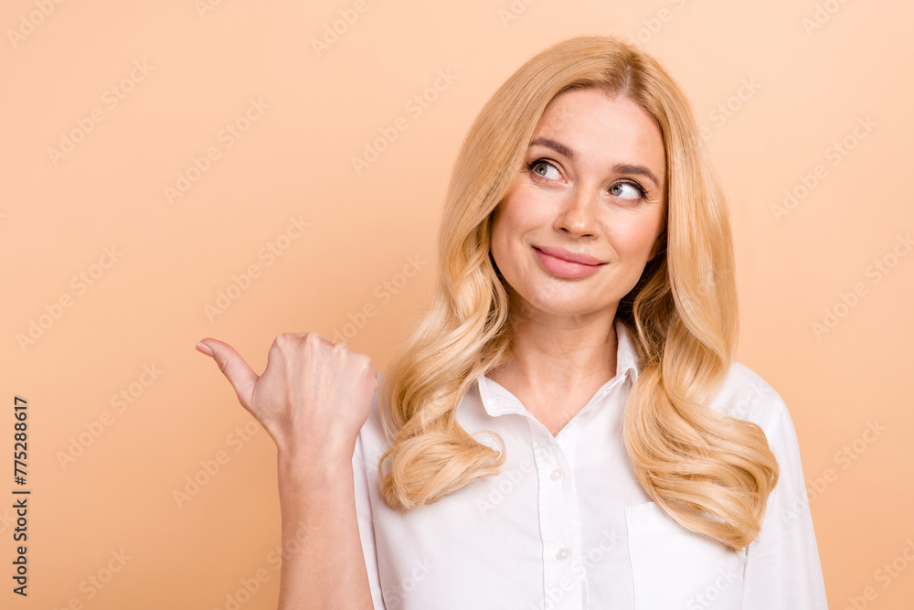 Photo of young charming blond mature employee woman formal uniform pointing empty space open vacancy isolated on beige color background Photo of young charming blond mature employee woman formal uniform pointing empty space open vacancy isolated on beige color background