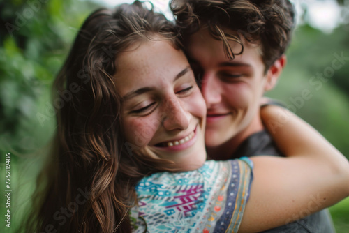 A man and woman are hugging and smiling with their eyes closed