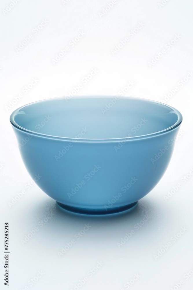 A blue bowl on a white table, suitable for kitchen or dining room decor A blue bowl on a white table, suitable for kitchen or dining room decor
