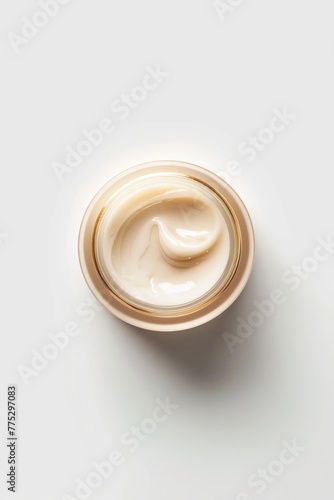 A jar of cream sitting on top of a table. Perfect for beauty or skincare concepts