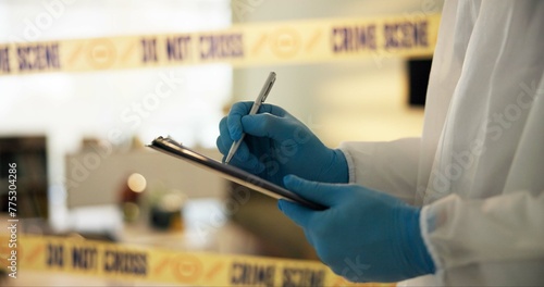 Hand, house and crime scene with writing for evidence or notes in robbery for evidence, safety and report. Forensics, police tape and investigation at home for dna, analysis and criminal activity. photo