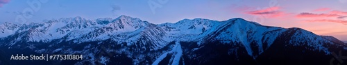 Ideal for large bilboards projects: Long Panoramatic view on the Rohace mountains peaks covered on snow in West Tatras, Slovakia, illuminated by evening orange sky.  photo