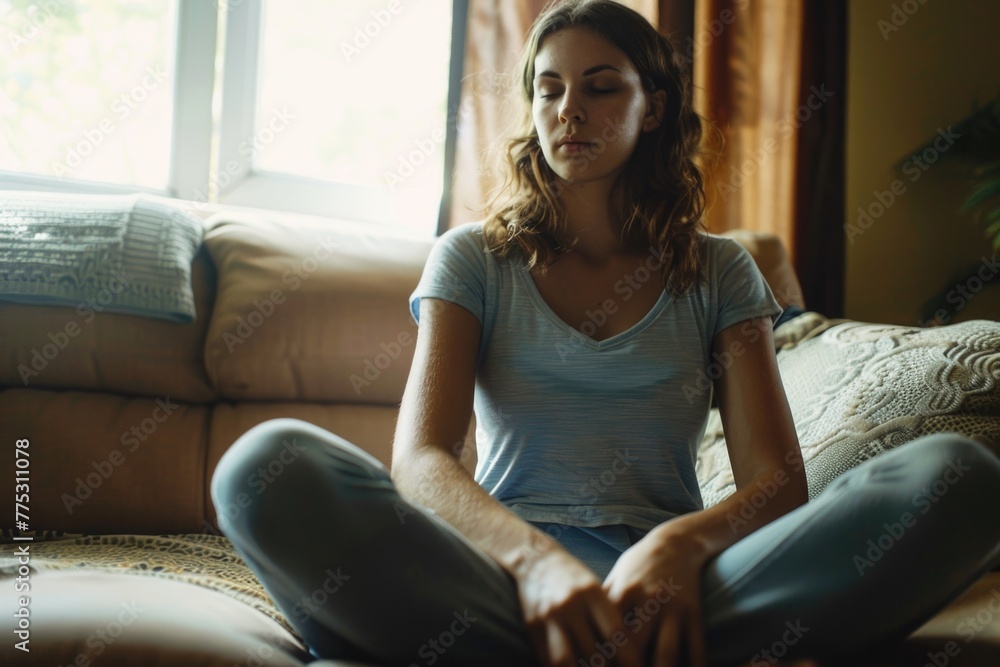 Woman sitting on a couch with closed eyes, suitable for relaxation concept Woman sitting on a couch with closed eyes, suitable for relaxation concept