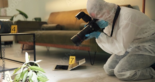 Csi, photographer and evidence at crime scene for investigation of house burglary or murder analysis. Forensic, person and digital pictures in hazmat for observation, examination and case research photo