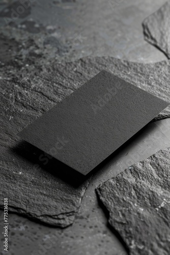 Black paper resting on a rock, suitable for various design projects