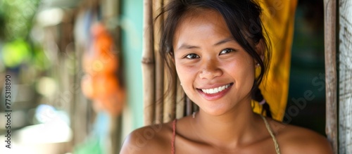 Smiling woman in a red bikini top standing in front of a wall