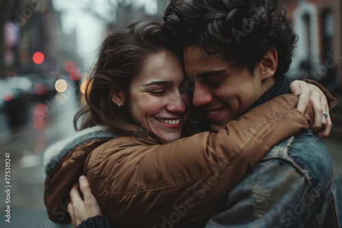 A man and a woman hugging each other and smiling