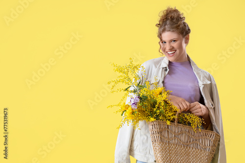 Happy young woman holding w...