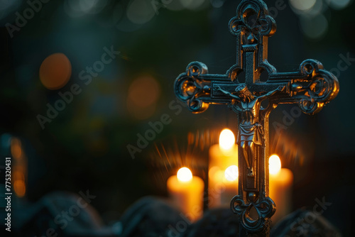 A black cross with a crucifix on top of it is lit by candles