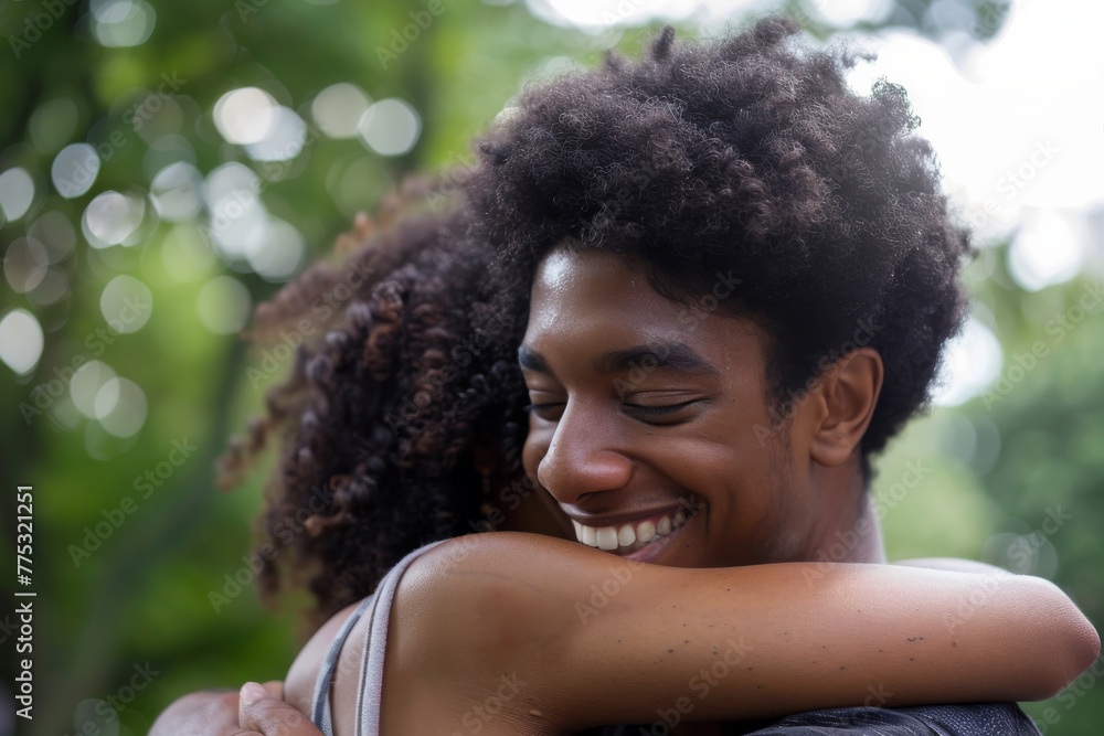 Fototapeta premium A man and woman hugging and smiling with trees in the background