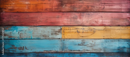 Close up view of a vibrant painted wood wall with peeling colorful paint layers, adding a textured and rustic charm to the background