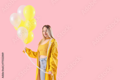 Young woman in raincoat wit...