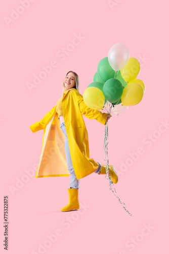 Young woman in raincoat wit...