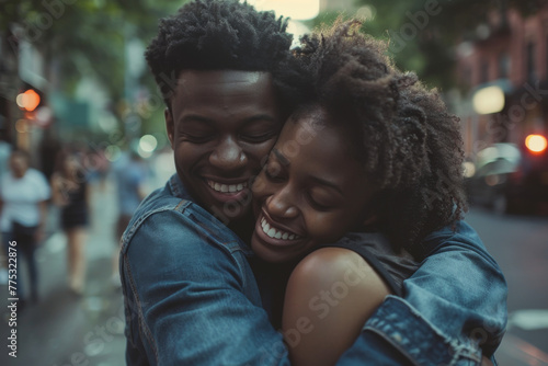 A man and woman hugging and smiling with their eyes closed