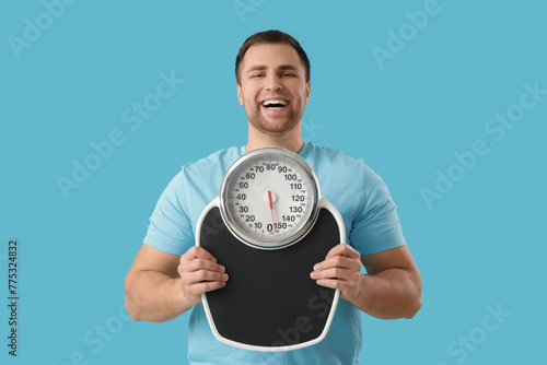 Young man with weight scale...
