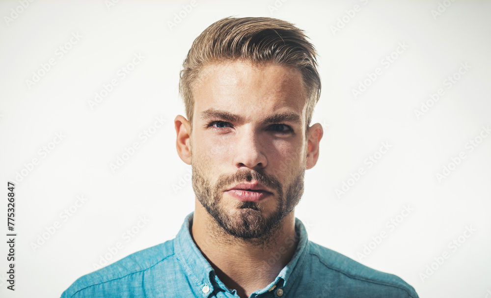 Fototapeta premium Portrait serious fashionable bearded man in denim shirt. Handsome businessman in casual wear. Sexy male model with beard and mustache. Fashion for men. Attractive unshaven guy with stylish hairstyle.