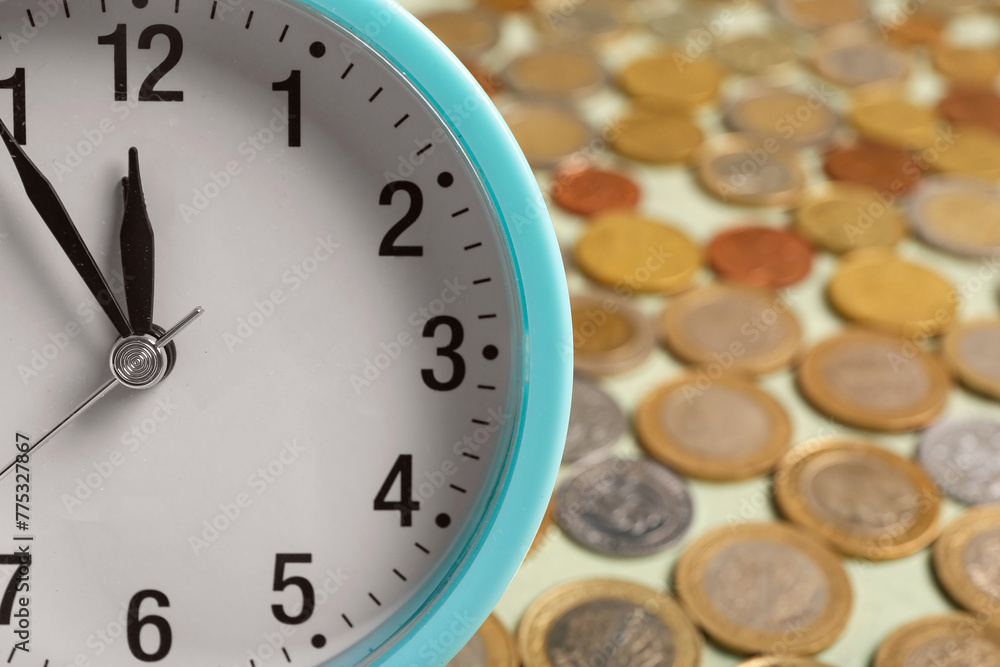 Composition with blue alarm clock and lots of coins on green background. Time management concept. Closeup Composition with blue alarm clock and lots of coins on green background. Time management concept. Closeup