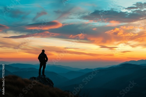 A lone hiker contemplates the vast mountain range ahead, symbolizing peace and solitude in nature